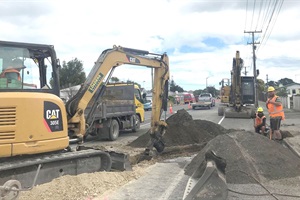 Workers prepare to install new water infrastructure pipes